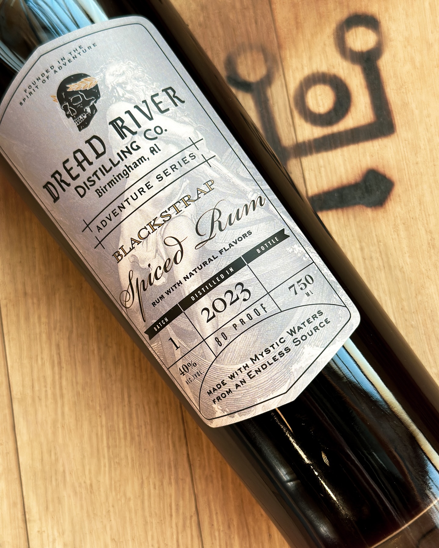 A close-up of a bottle of spiced rum from Dread River Distilling Co., highlighting the intricate design and rich amber color.