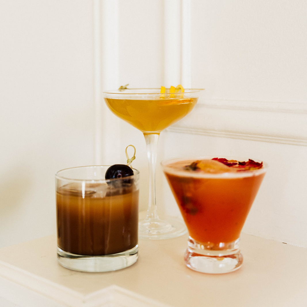 Three glasses of unique whiskey cocktails crafted with Dread River Whiskey.
