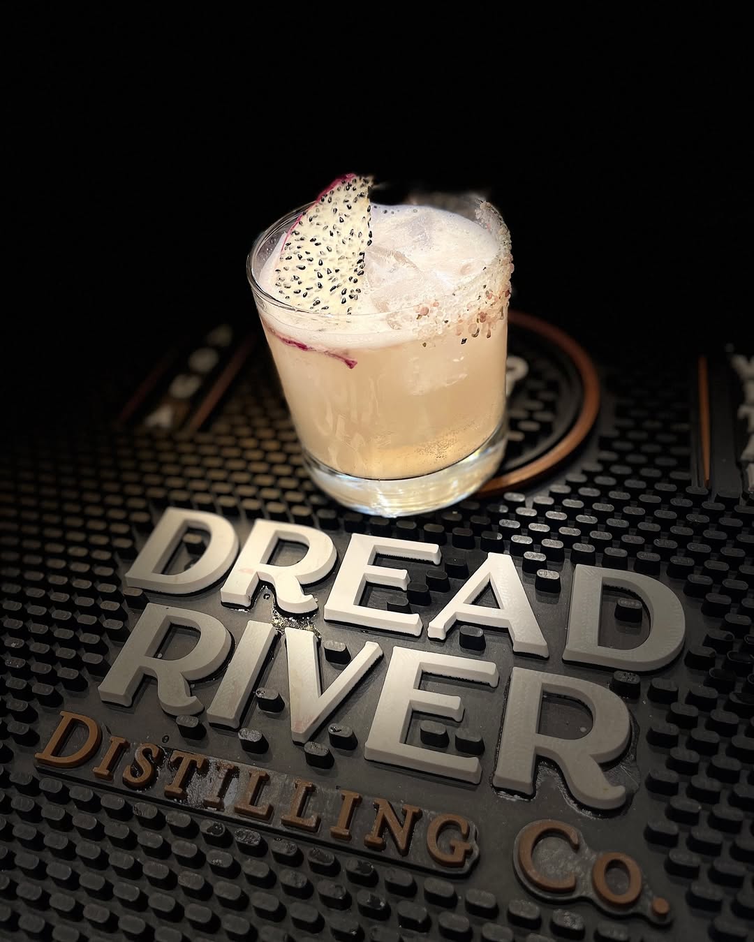 A shot of a glass of a cocktail made with Dread River Whiskey.