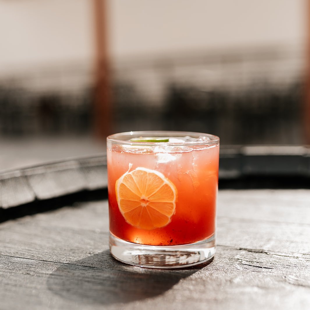 Rye whiskey cocktail from Dread River in clear glass, highlighting rich amber color and smooth texture.