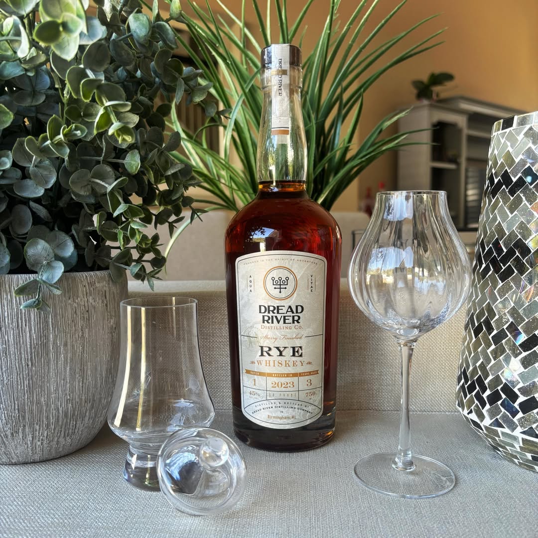 A bottle of Dread River Rye Whiskey beside different tasting glasses.