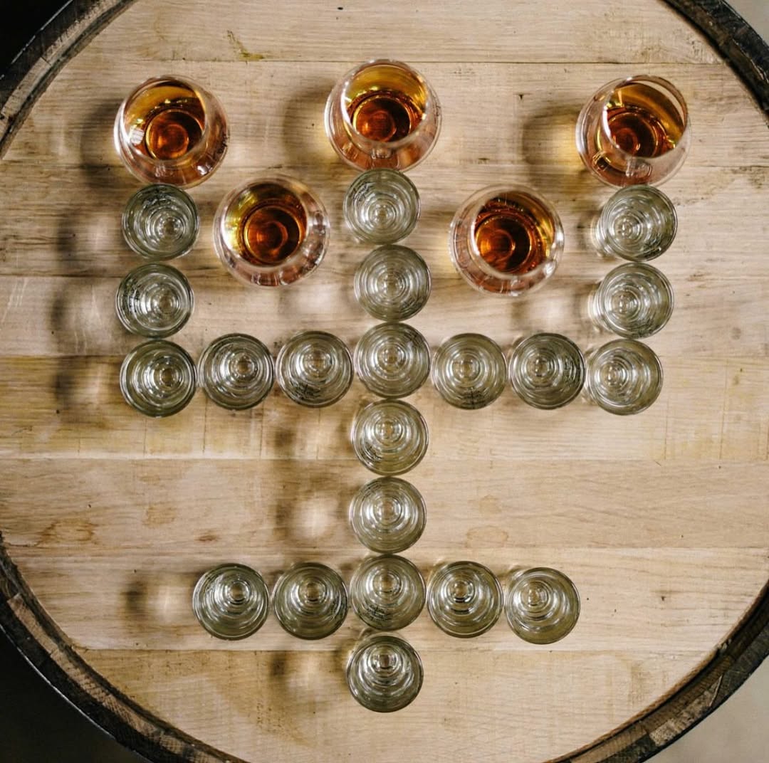 The Dread River logo made with glasses of Dread River vodka and whiskey.