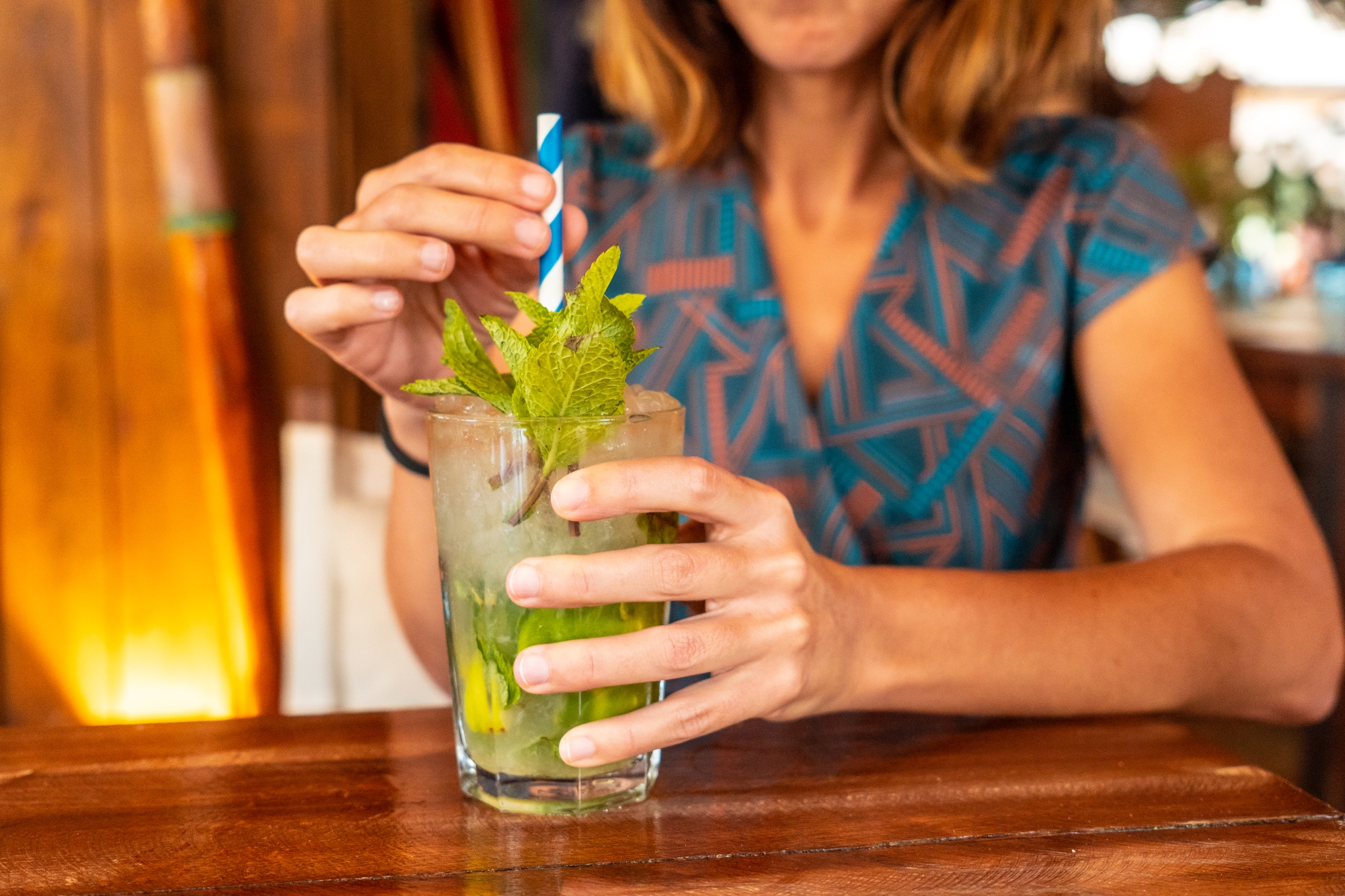 A woman tries a Mint Julep drink made with Dread River spirits.