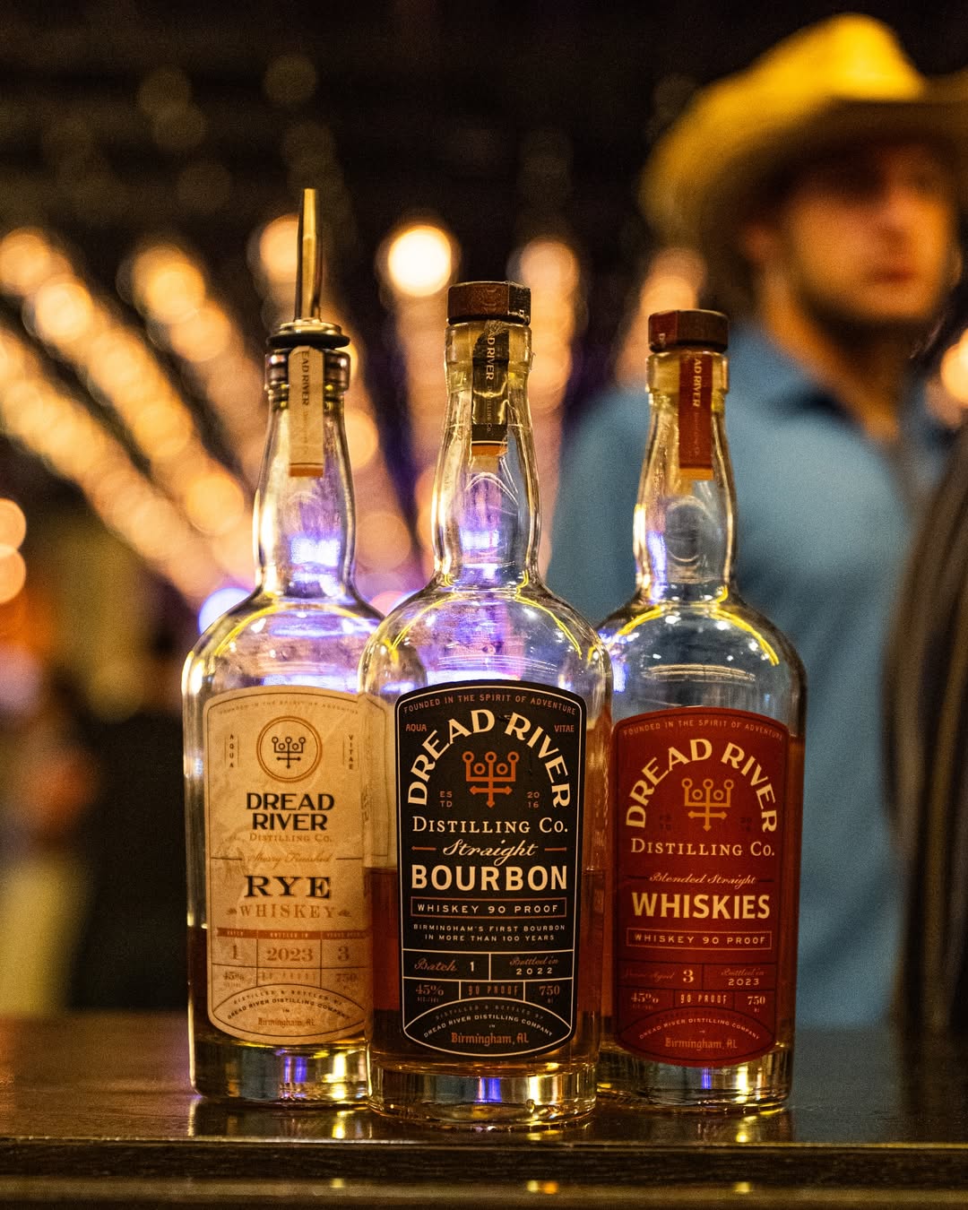 Bottles of Dread River rye whiskey and straight bourbon displayed on a bar counter.