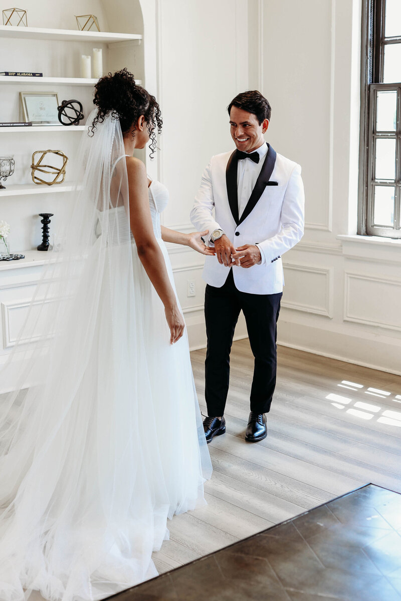 Wedding couple sharing a quiet moment in a bright event space at Dread River Distillery in Birmingham, Alabama.