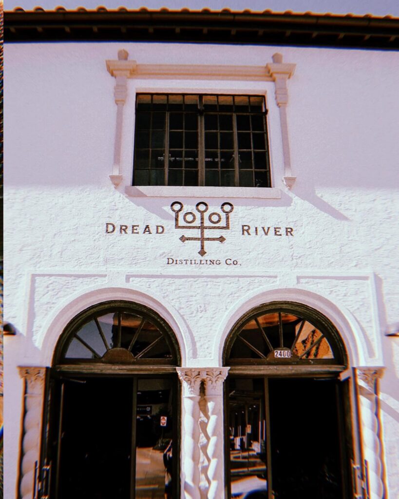 Dread River Distilling Co. entrance with its logo above the arched doors.